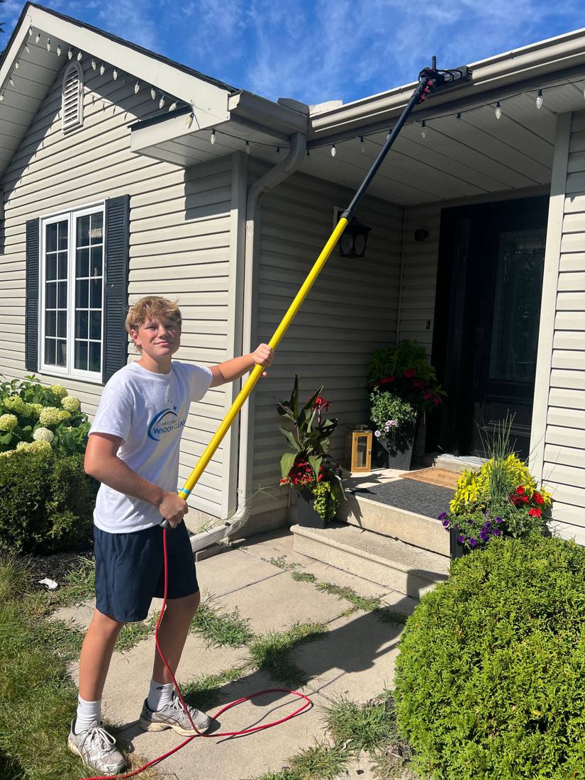 Cleaning gutters on a bungalow